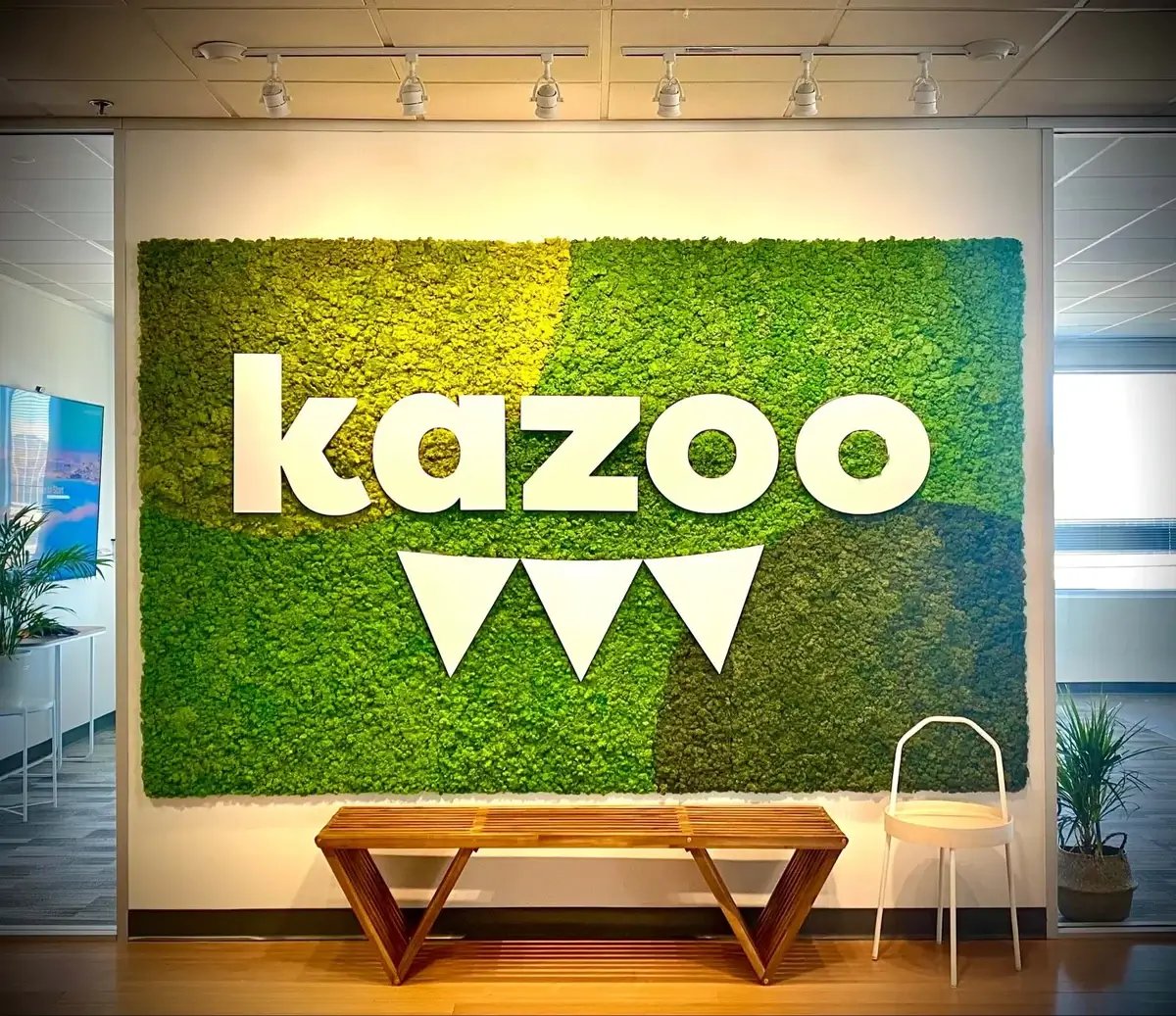 Moss wall in an office with brand signage